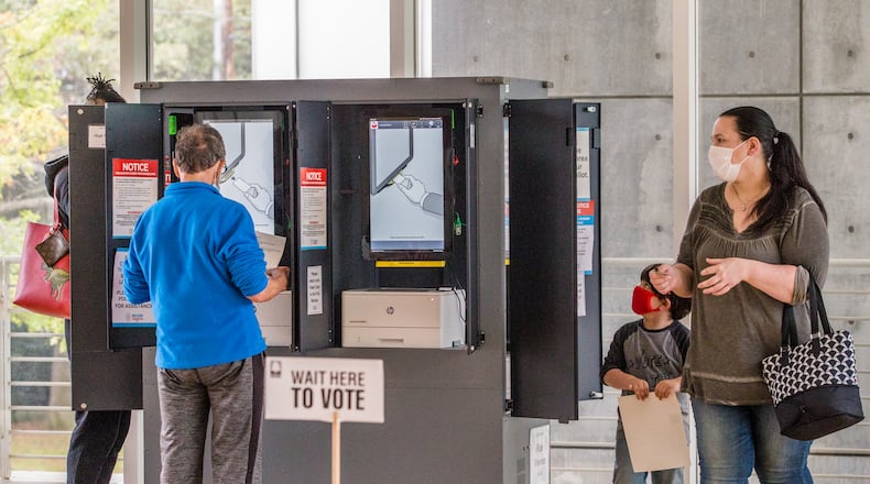 Early voting began Monday in Fulton County. Voters waited between 2 1/2 and 3 hours to cast ballots in the Anne Cox Chambers Wing of the High Museum of Art, where six ballot stations operated without any major technical problems. (Jenni Girtman for The Atlanta Journal-Constitution)