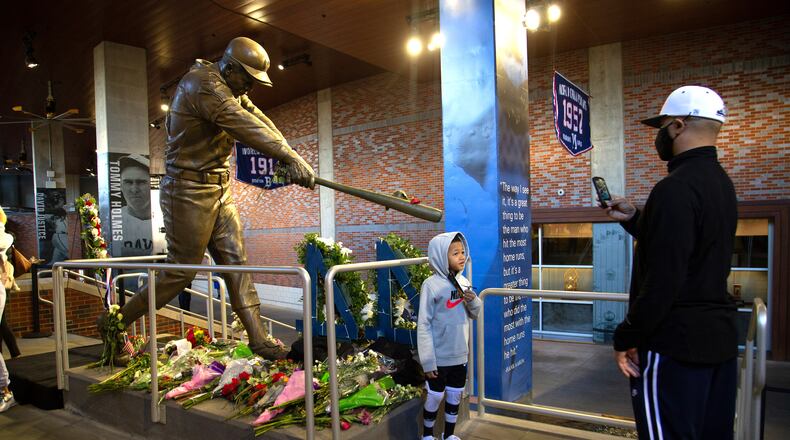 People take photos in front of the Hank Aaron statue in the Monument Garden at Truist Park on Saturday, January 23, 2021, a day after the baseball legend died at age 86. (Photo: Steve Schaefer for The Atlanta Journal-Constitution)