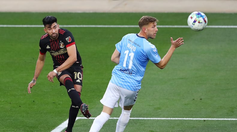 Atlanta United's Marcelino Moreno takes a shot on goal past Chattanooga FC defender Travis Ward in the U.S. Open Cup on Wednesday night in Kennesaw. (Curtis Compton / Curtis.Compton@ajc.com)