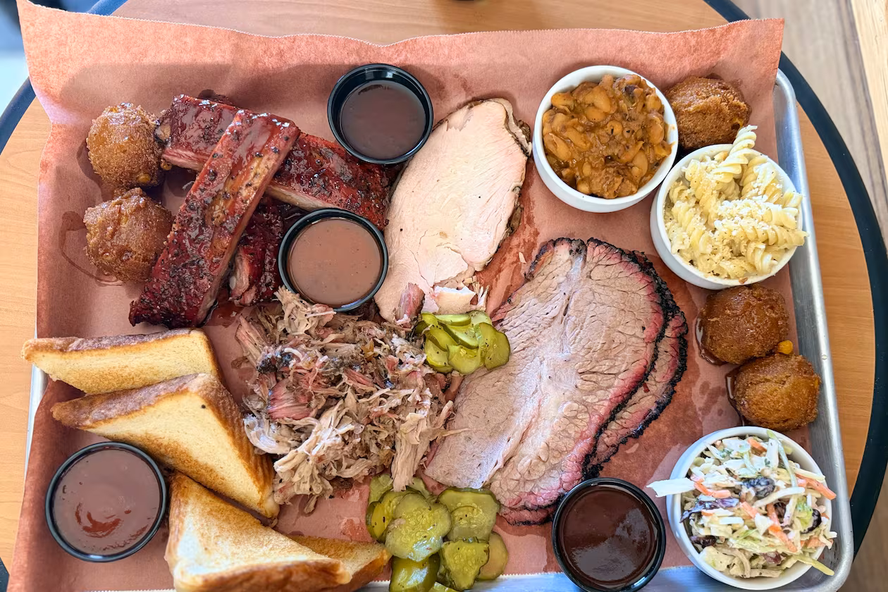 A barbecue platter is filled to the brim at Disruption BBQ in Henry County. (Justin Brown for the AJC)