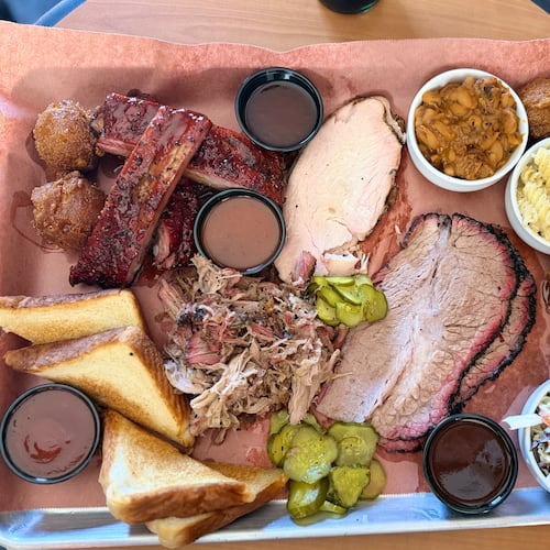 A barbecue platter is filled to the brim at Disruption BBQ in Henry County. (Justin Brown for the AJC)