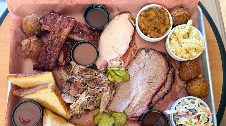 A barbecue platter is filled to the brim at Disruption BBQ in Henry County. (Justin Brown for the AJC)