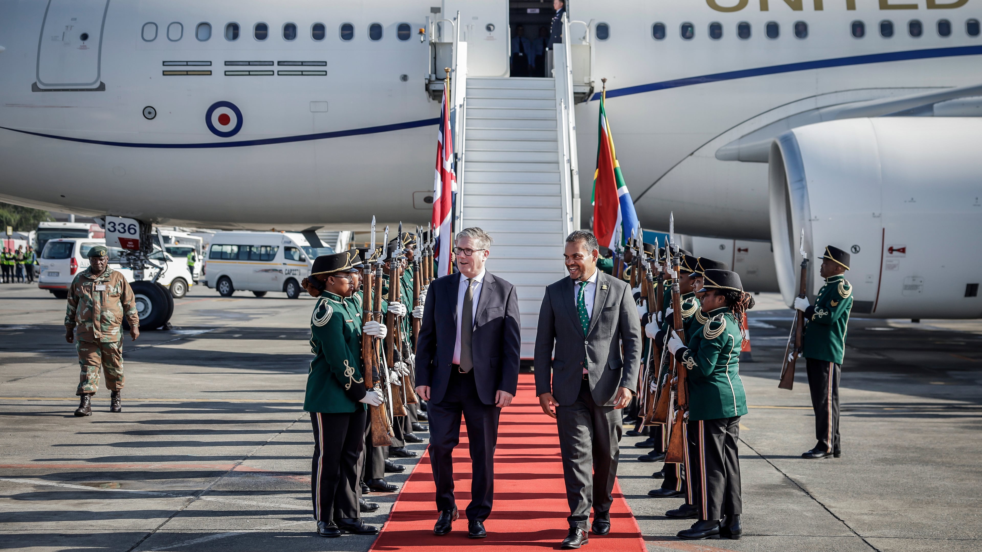 Britain's Prime Minister Keir Starmer, center left is welcomed by a South African representative upon his arrival at the OR Tambo International airport in Ekurhuleni on Friday, Nov. 21, 2025 ahead of the G20 leaders' Summit. ( Marco Longari /Pool Photo via AP)