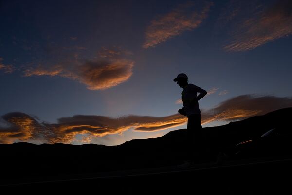 Danny Westergaard runs as the sun rises during the Badwater 135 Ultramarathon, Wednesday, July 9, 2025, near Lone Pine, Calif. (AP Photo/John Locher)