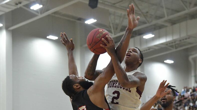 Morehouse Tyrius Walker (2) grabs a rebound over Clark Atlanta Michael Vigilance (15) during the Morehouse vs Clark Atlanta college basketball game at Morehouse's Forbes Arena on Friday, February 22, 2018.