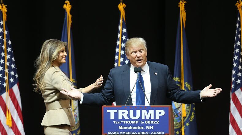 Republican presidential candidate Donald Trump speaks as his wife, Melania Trump, walks near during a Monday campaign rally in Manchester, N.H. Joe Raedle/Getty Images