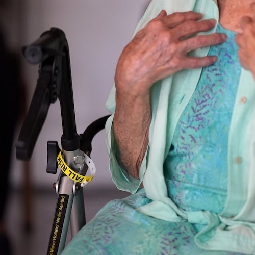 A "Fall Risk" alert bracelet marks the walker of Anna Fischbein as she speaks about the loss of a beloved Haitian home health care worker whose Temporary Protected Status expired this week, during an interview in her apartment, Thursday, July 30, 2026, in Sunny Isles Beach, Fla. (AP Photo/Rebecca Blackwell).