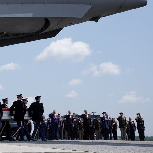 President Donald Trump and Secretary of Defense Pete Hegseth and others, salute as a U.S. Army carry team moves a transfer case containing the remains of Sgt. Angel S. Rampersad, of Ozone Park, N.Y. Wednesday, July 22, 2026, at Dover Air Force Base, Del. (AP Photo/Matt Rourke)