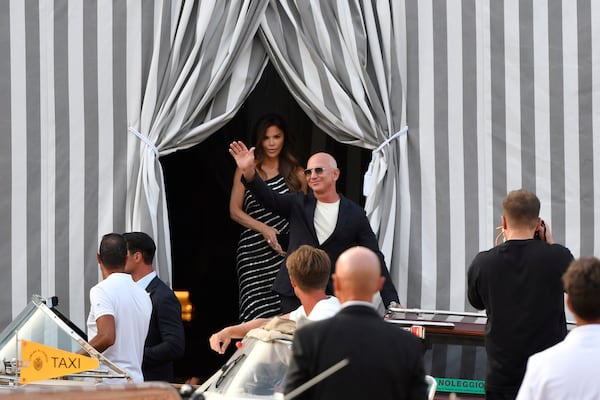 Amazon multi-billionaire founder Jeff Bezos, right, and Lauren Sanchez leave a hotel in Venice, Italy, on Wednesday, June 25, 2025, ahead of festivities in the lagoon city reportedly linked to their wedding. (AP Photo/Luigi Costantini)