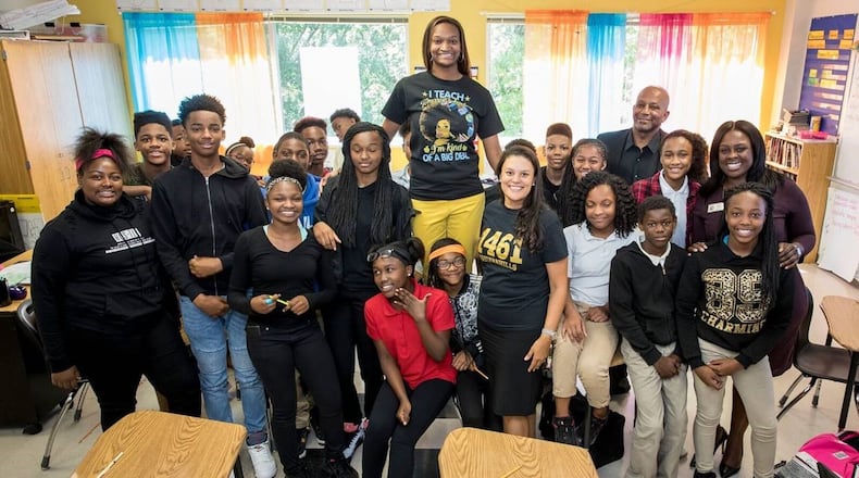 Atlanta Public Schools' Districtwide Teacher of the Year Mahoganey Jackson is surrounded by Superintendent Meria Carstarphen and others, including members of the teacher's eighth grade class at Sylvan Hills Middle School. Photo courtesy of Ben Dashwood, Raftermen Photography