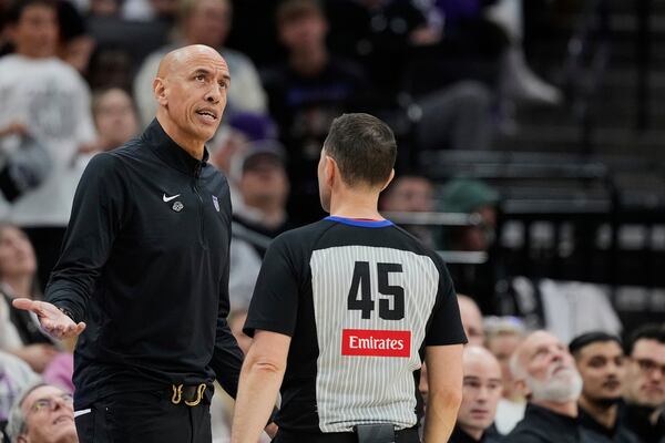 Sacramento Kings interim head coach Doug Christie, left, talks with referee Brian Forte (45) during the second half of an NBA play-in tournament basketball game against the Dallas Mavericks, Wednesday, April 16, 2025, in Sacramento, Calif. (AP Photo/Godofredo A. Vásquez)
