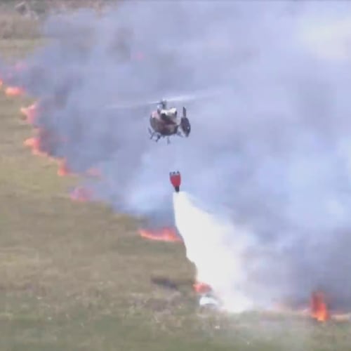 This image taken from a WSVN video shows firefighters battling a wildfire Wednesday, April 22, 2026, in Broward County, Fla. (WSVN/ABC Miami via AP)