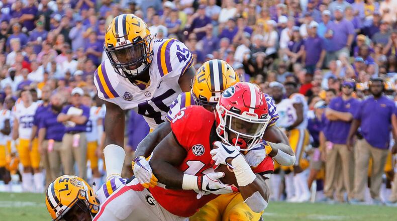 Bulldogs running back Elijah Holyfield scores a touchdown in the third quarter against LSU. (BOB ANDRES / BANDRES@AJC.COM)