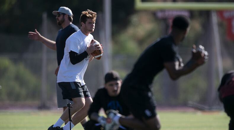 USC quarterback Sam Darnold at a spring workout with quarterbacks coach Jordan Palmer, left, at San Clemente High School on May 13, 2017.  (Robert Gauthier/Los Angeles Times/TNS)