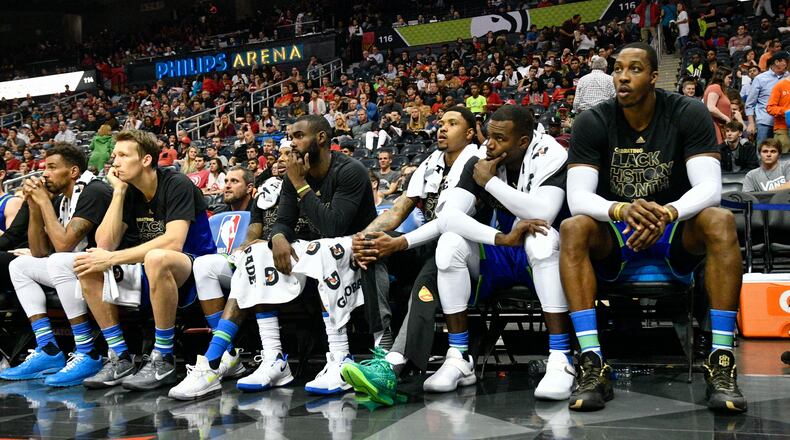 Atlanta Hawks team members watch from the bench during the final minute of an NBA basketball game against the Miami Heat, Friday, Feb. 24, 2017, in Atlanta. (AP Photo/John Amis)