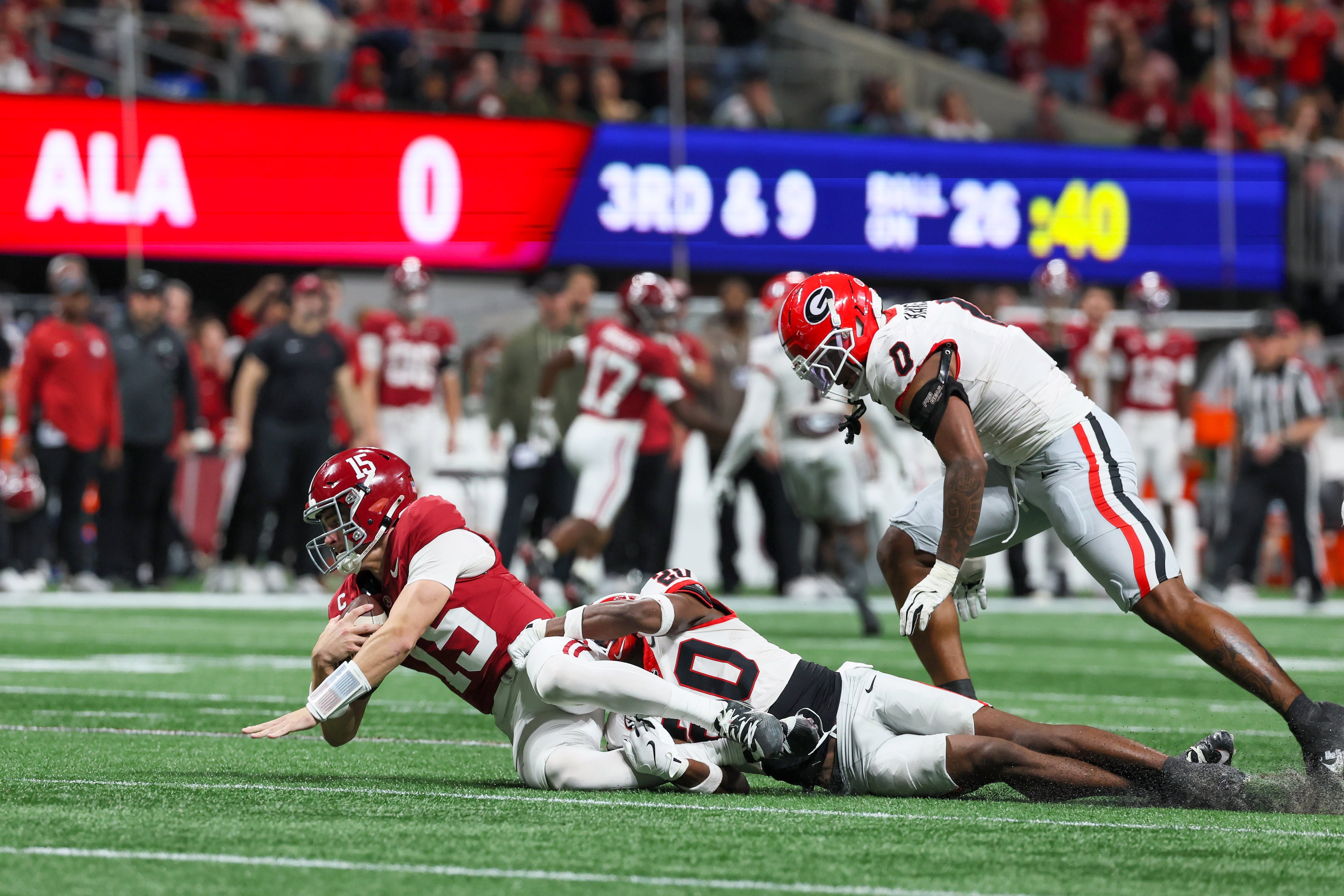 Alabama quarterback Ty Simpson (15) is sacked by Georgia defensive back Jacorey Thomas (20) during the third quarter of the SEC Championship game at Mercedes-Benz Stadium, Saturday, Dec. 6, 2025, in Atlanta. (Jason Getz / AJC)