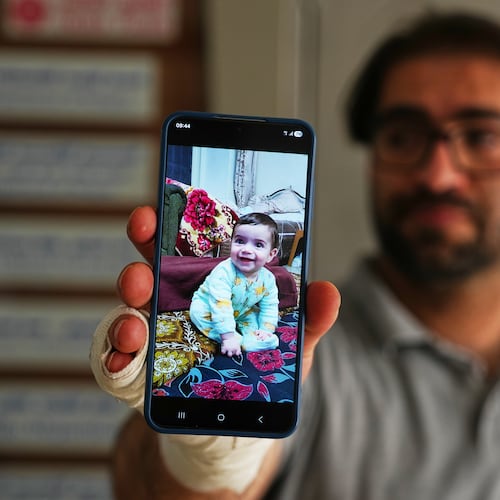 Fahd Abu Haikal, 41 displays a mobile photo of his seven month old Palestinian baby boy Sam, who was killed on Friday when Israeli soldiers fired at the vehicle carrying him and his parents, in Tel Rumeida, at a hospital in the West Bank city of Hebron Saturday, June 6, 2026. (AP Photo/Mahmoud Illean)