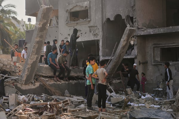 Palestinians inspect a house destroyed by an Israeli airstrikes in Deir al-Balah, Gaza, Wednesday, May 21, 2025. (AP Photo/Abdel Kareem Hana)