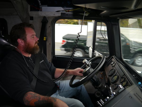 Chad Roberts, who owns a small trucking company, delivers a forklift in metro Atlanta on Nov. 6, 2021.