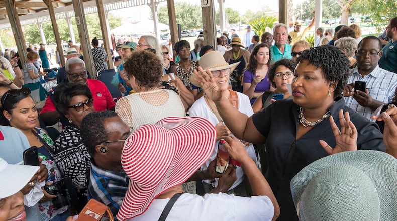 Georgia Gubernatorial candidate Stacey Abrams tries to organize a group of supporters who want to take a photo with her following a campaign stop in Brunswick, Georgia, September 23, 2018. .