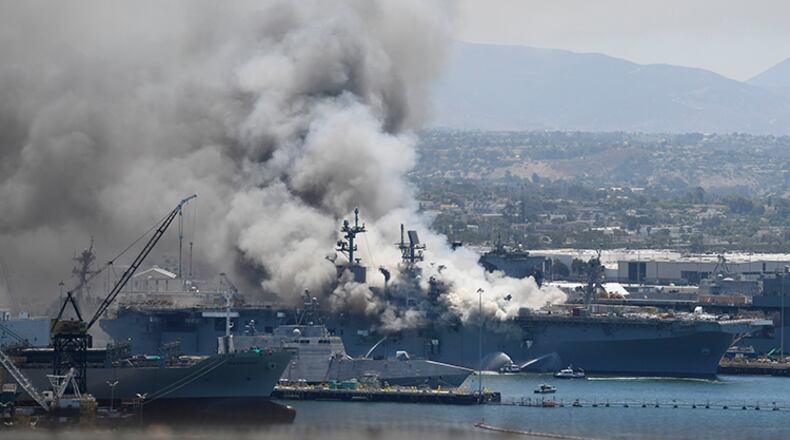 Smoke rises from the USS Bonhomme Richard at Naval Base San Diego after an explosion and fire Sunday on board the ship.