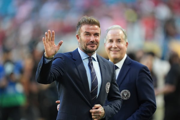 Inter Miami co-owner David Beckham, front, waves fans accompanied by managing owner Jorge Mas during the Club World Cup group A soccer match between Al Ahly and Inter Miami in Miami, Fla., Saturday, June 14, 2025. (AP Photo/Rebecca Blackwell)