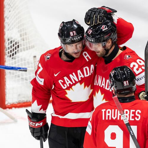 Canada's Parker Wotherspoon, center, celebrates his goal with Canada's Sidney Crosby, left, and Canada's John Tavares, right, during the 2026 IIHF Men's Ice Hockey World Championship preliminary round group B game between Canada and Denmark, in Fribourg, Switzerland, Monday, May 18, 2026. (Cyril Zingaro/Keystone via AP)