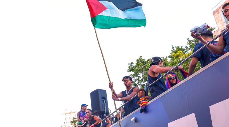 FC Barcelona player Lamine Yamal holds a Palestinian flag as he celebrates with his team atop a bus after winning the Spanish La Liga title in Barcelona, Spain, Monday, May 11, 2026. (AP Photo)