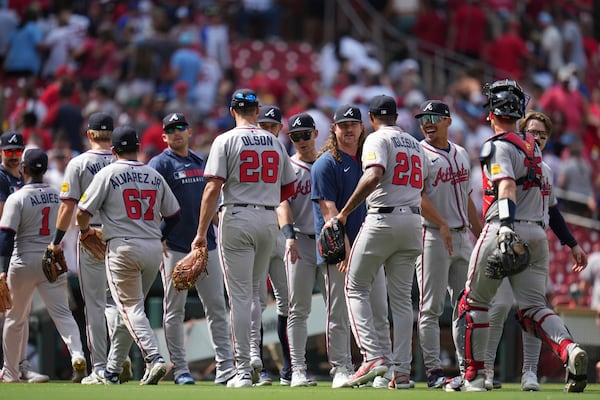 Members of the Atlanta Braves celebrate a victory over the St. Louis Cardinals following a baseball game Saturday, July 12, 2025, in St. Louis. (AP Photo/Jeff Roberson)