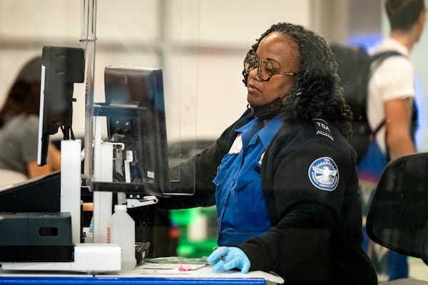 A Transportation Security Administration Agent checks the identification of travelers at Hartsfield-Jackson Atlanta International Airport. Wednesday, Oct. 1, 2025. (Ben Hendren for the AJC)