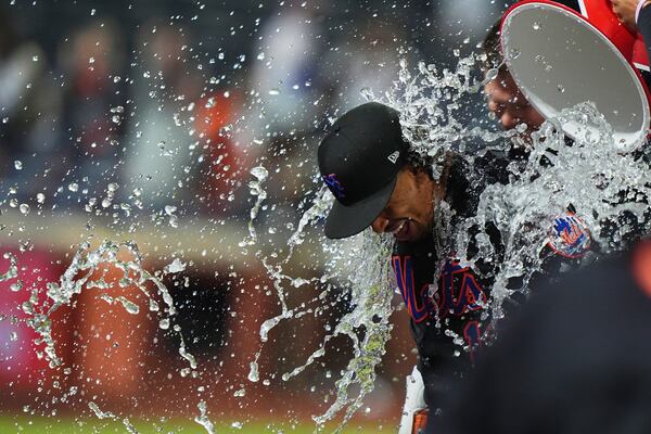 Teammates dunk water on New York Mets' Francisco Lindor after a baseball game against the St. Louis Cardinals Friday, April 18, 2025, in New York. (AP Photo/Frank Franklin II)
