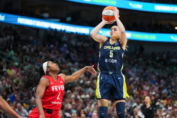 Dallas Wings guard Paige Bueckers (5) shoots against Indiana Fever guard Aari McDonald (2) during the first half of a WNBA basketball game Friday, June 27, 2025, in Dallas. (AP Photo/Julio Cortez)