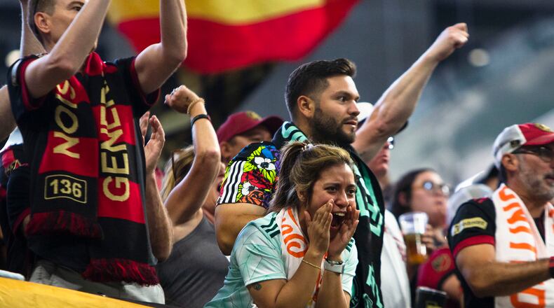 An Atlanta United fan cheers during an MLS game against the Philadelphia Union on Sept. 17 at Mercedes-Benz Stadium. (CHRISTINA MATACOTTA / FOR THE ATLANTA JOURNAL-CONSTITUTION)