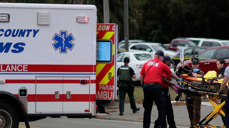 A person is transported from the scene of a shooting at a yoga studio in Tallahassee, Florida, on Friday, Nov. 2, 2018. A gunman killed two women and wounded five others when he opened fire on people inside.