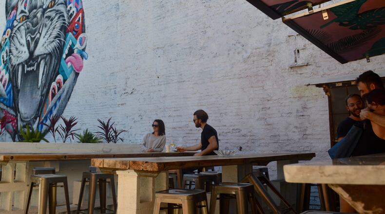 The patio at 8ARM includes long communal tables that look over Ponce de Leon Ave.