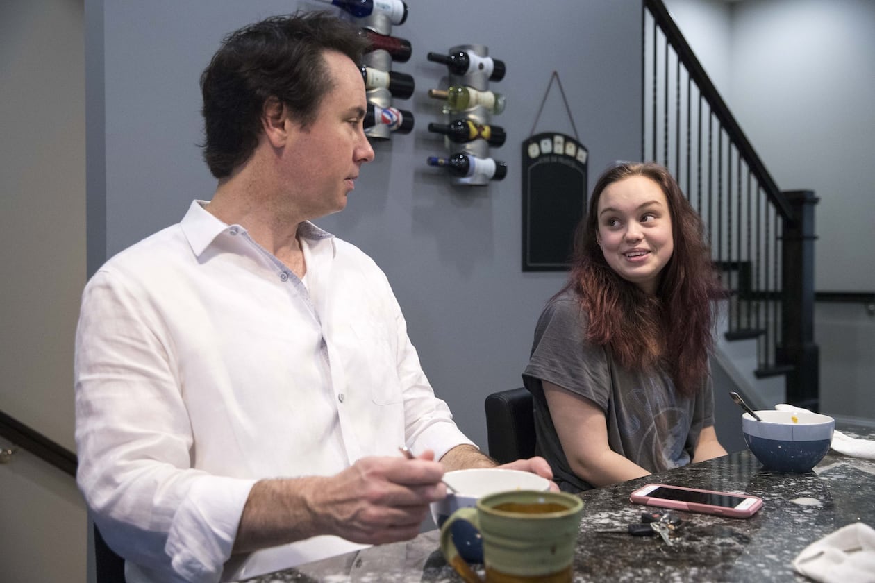 Johnny Edwards and his daughter, Grace Edwards, 17, start their weekday mornings with a bowl of cereal in their Sandy Springs home. Johnny has raised Grace on his own since she was 5. ALYSSA POINTER/ATLANTA JOURNAL-CONSTITUTION