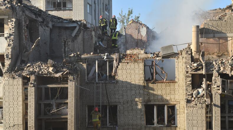 Rescuers search through the rubble of a residential building following air attack in Lviv, Ukraine, Thursday, July 30, 2026. (AP Photo/Mykola Tys)