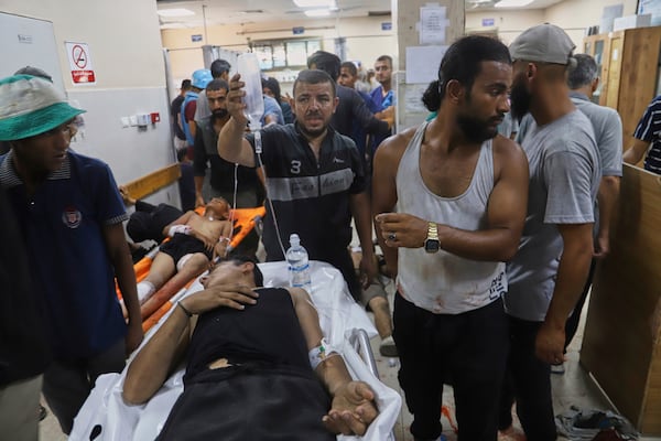 Palestinians wounded while returning from one of the Gaza Humanitarian Foundation distribution centers operated by the U.S.-backed organization, according to Nasser Hospital, are treated in Khan Younis, Monday, June 30, 2025. (AP Photo/Mariam Dagga)