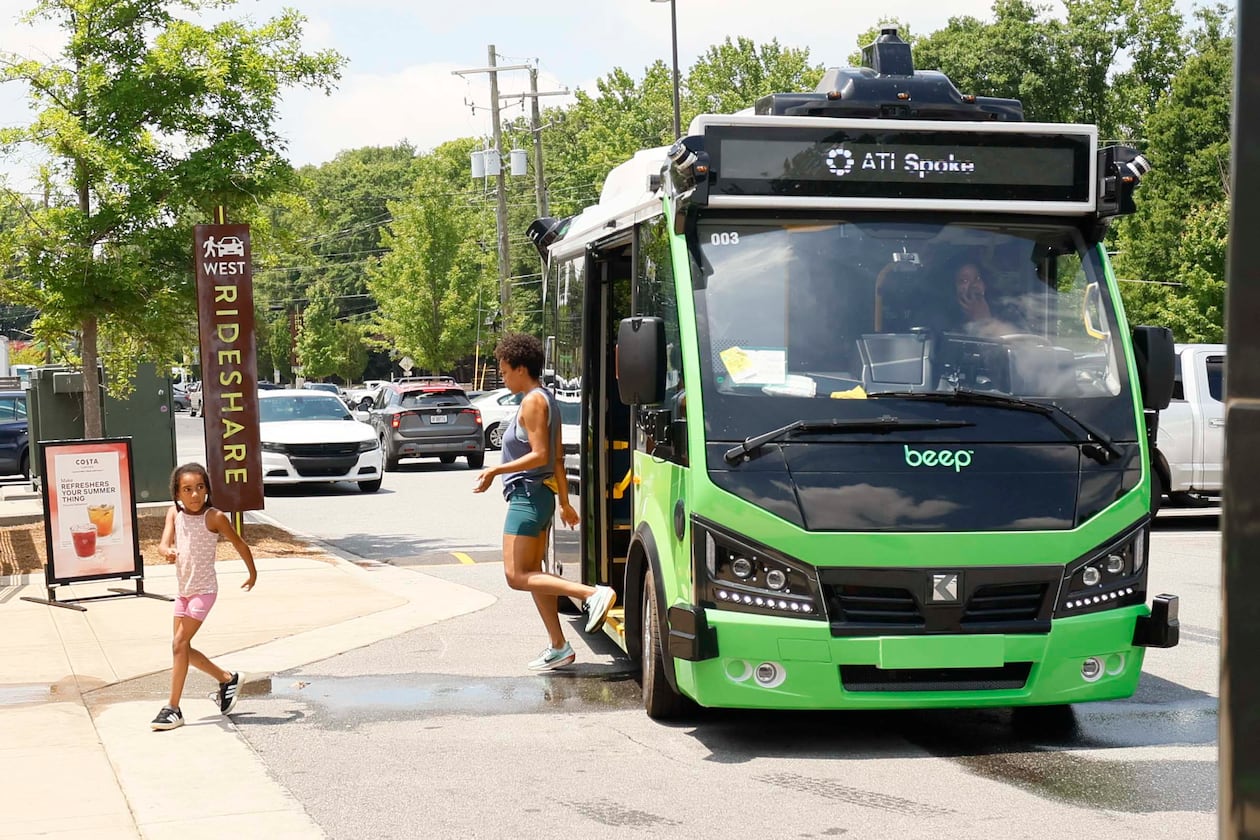 Passengers are seen getting off an ATL Spoke bus as they arrive at the Lee + White District on Monday, June 1, 2026. The ATL Spoke, an autonomous pilot program, began offering service recently. It connects the West End MARTA station and the Lee + White District. It operates seven days a week. (Miguel Martinez/AJC)