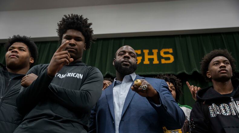 Students at Grayson High School celebrate alongside their new head football coach, Greg Carswell (center), on Wednesday, Jan. 15, 2026. (Olivia Bowdoin for the AJC)