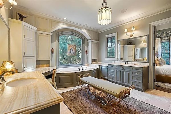 Josh Brolin's main bedroom bath offers two boutique-style walk-in closets, a jetted tub set beneath beautiful stained glass, and a separate shower. (Courtesy of Jacob Bean)