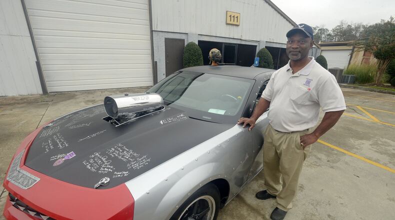 Clayton County resident Randy Gallop just finished a two-year project transforming the charred remains of a 2010 Chevrolet Camaro into a replica of the P-40 Warhawk airplane the famed WWII black flying squadron Tuskegee Airmen flew into battle. Gallop bought the car for $500, sunk $70,000 into it, adding a red tail, a shark teeth grill, WWII-style plane rivets and a souped-up engine that will eventually reach 2,000-horsepower. He plans to take the car around the country to collect 5,000 signatures from active and retired military vets in the five branches of service. So far, he has about 50 signatures, including a half-dozen from surviving Tuskegee airmen and their flight crew and a commitment for a two-star general’s signature. KENT D. JOHNSON/KDJOHNSON@AJC.COM