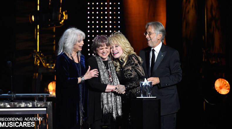 Honoree Dolly Parton accepts the 2019 MusiCares Person of the Year Award from (L-R) Emmylou Harris, Linda Ronstadt, and Recording Academy and MusiCares President/CEO Neil Portnow onstage during MusiCares Person of the Year honoring Dolly Parton at Los Angeles Convention Center on February 8, 2019 in Los Angeles, California.
