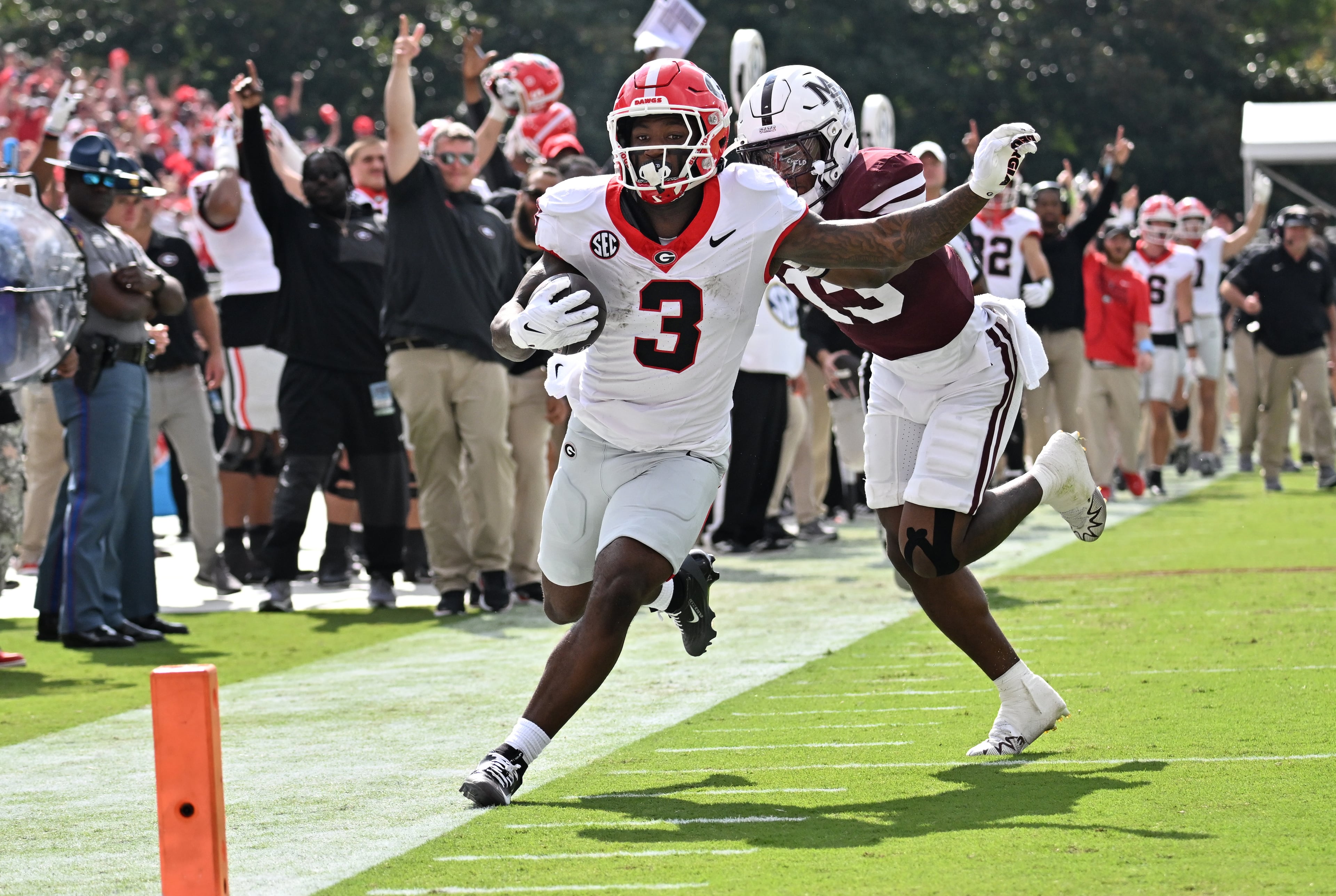 Georgia running back Nate Frazier (3) runs down the sidelines until he is pushed by Mississippi State safety Jahron Manning (13) during the first half in an NCAA football game at Davis Wade Stadium, Saturday, November 8, 2025, in Starkville, Mississippi. (Hyosub Shin / AJC)