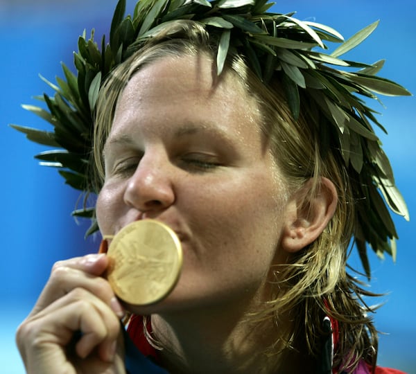 FILE -Kirsty Coventry, of Zimbabwe, kisses her gold medal after winning the 200-meter backstroke at the Olympic Aquatic Centre during the 2004 Olympic Games in Athens, Aug. 20, 2004. (AP Photo/Mark Baker), File)