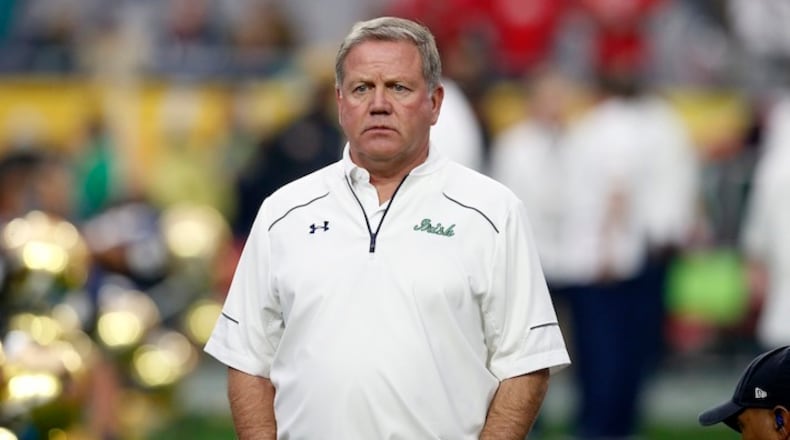 Notre Dame head coach Brian Kelly watches his players prior to the Fiesta Bowl NCAA College football game against Ohio State , Friday, Jan. 1, 2016, in Glendale, Ariz. (AP Photo/Rick Scuteri)