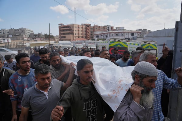 Palestinians carry the body of Reem Al-Akhras who was killed while heading to a Gaza aid hub, during her funeral in Khan Younis, southern Gaza Strip, Tuesday, June 3, 2025. (AP Photo/Abdel Kareem Hana)