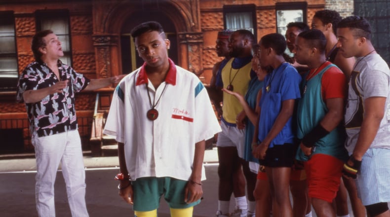 Portrait of American film director and actor Spike Lee (center) on the set of his film 'Do the Right Thing,' New York, 1989. Among the cast behind him is actor Danny Aiello (left).