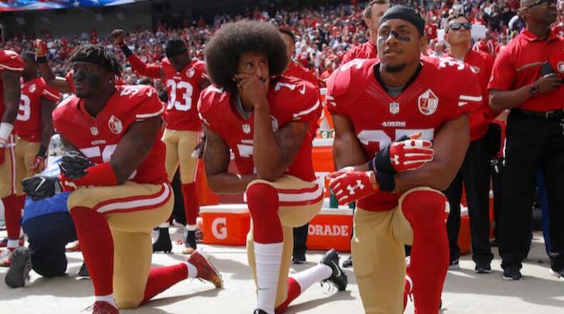 San Francisco 49ers’ Eli Harold (left), Colin Kaepernick (middle) and Eric Reid (right) kneel during the national anthem before their a game against the Dallas Cowboys on October 2, 2016. (Nhat V. Meyer/Bay Area News Group/TNS)
