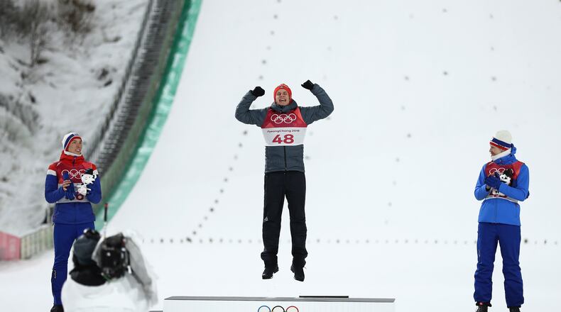 PYEONGCHANG-GUN, SOUTH KOREA - FEBRUARY 10: Gold medalist Andreas Wellinger of Germany (C) celebrates on the podium alongside silver medalist Johann Andre Forfang of Norway (L) and bronze medalist Robert Johansson of Norway (R) during the victory ceremony for the Ski Jumping - Men's Normal Hill Individual Final on day one of the PyeongChang 2018 Winter Olympic Games at Alpensia Ski Jumping Center on February 10, 2018 in Pyeongchang-gun, South Korea. (Photo by Lars Baron/Getty Images)